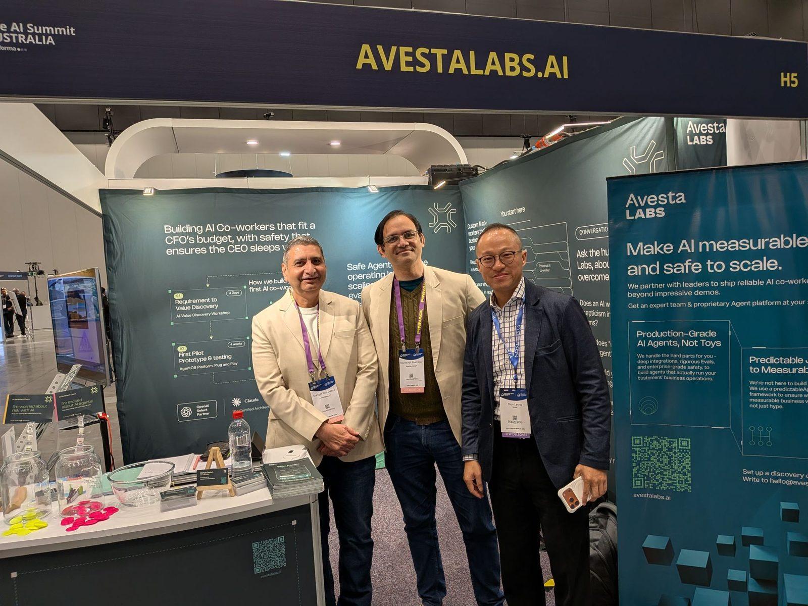 Two of the Avesta Labs team standing with a visitor at Stand H5, in front of the wall panel setting out the discovery and first pilot steps and a pull-up banner reading make AI measurable and safe to scale