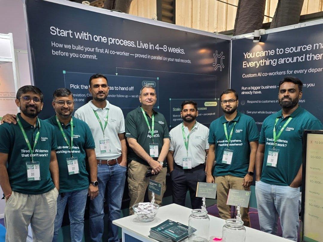 Seven members of the Avesta Labs team standing shoulder to shoulder at their PharmaTech Expo 2026 stand in Gandhinagar, in front of a wall panel headed start with one process, live in 4 to 8 weeks